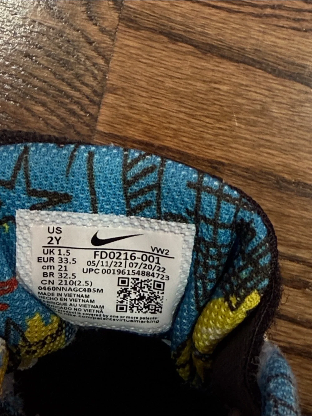 Nike Kids Black Sneakers with Blue, Red and Yellow Accents